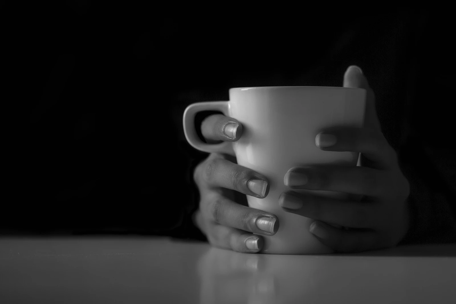 Hands cradling a coffee cup in a quiet moment
