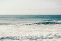 Gentle ocean waves breaking on a sandy shore